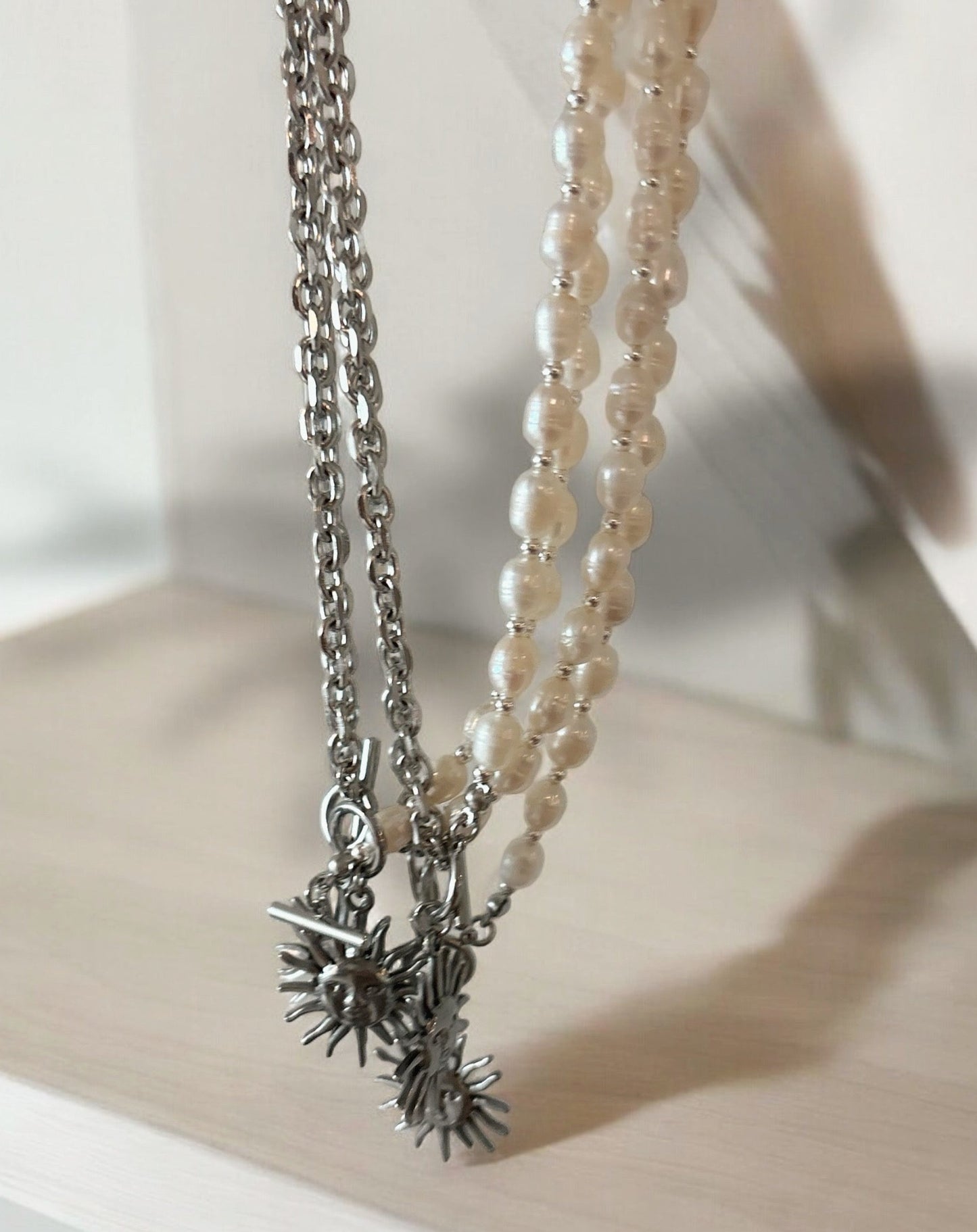 Half chain half pearls, with sun silver pendant